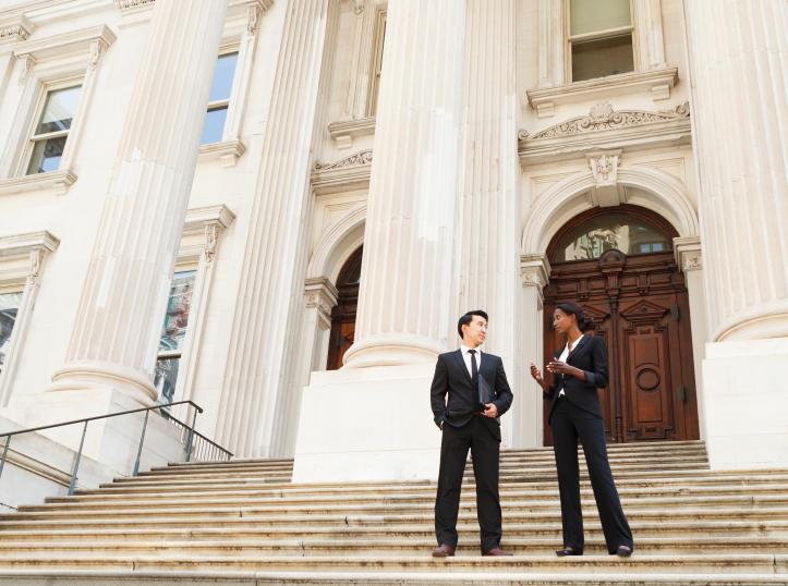 professionals talking on steps of building