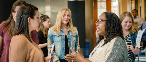 Professor chatting with students