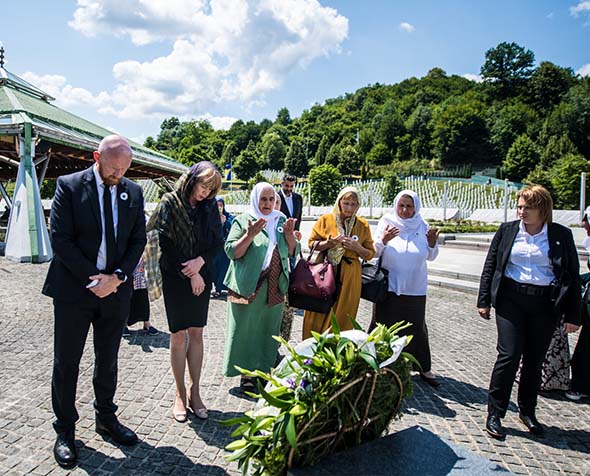 group of people standing at a memorial