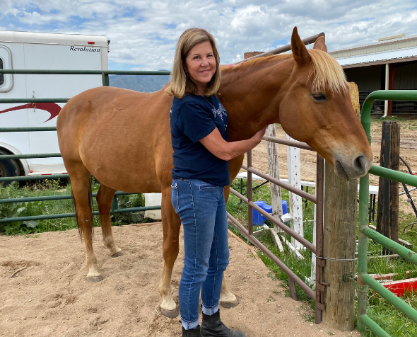 Floerke standing next to a horse
