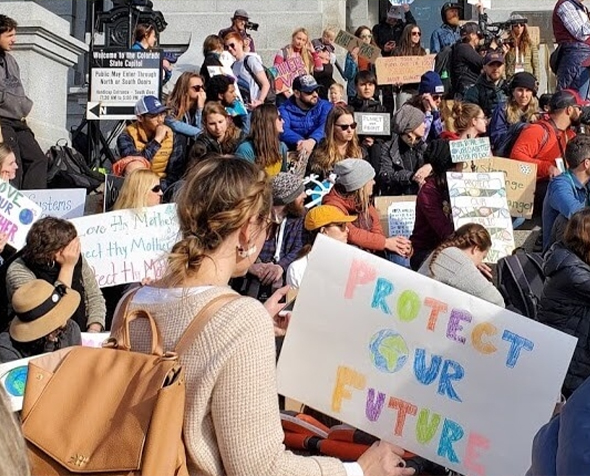 Activists at the 2020 Winter Outdoor Retailer Show climate strike demanding climate action now