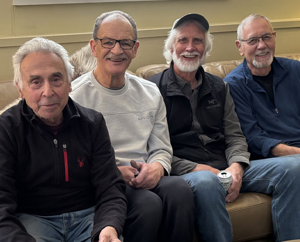 GSSW Professors Emeriti Walter LaMendola, William Cloud, Jeff Jenson, and Jim Moran gather to watch a recent Denver Broncos football game.