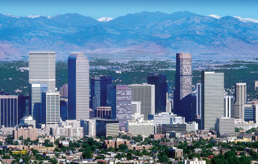 cityscape shot of denver with mountains in background