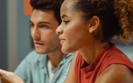 two people in front of a computer screen