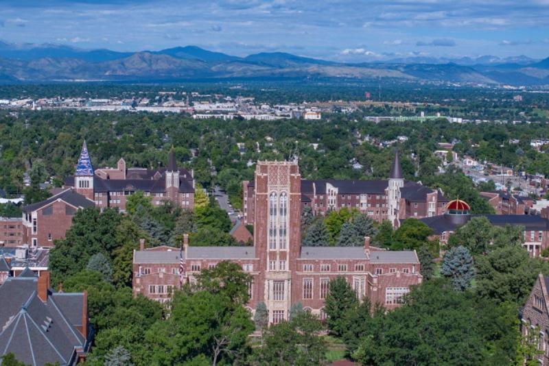 aerial shot over du campus with mountains in the background 