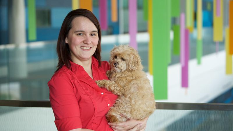 Whitney Romine holding therapy dog. 