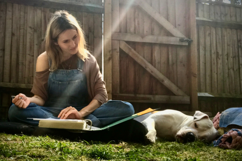 Mara-Daria Cojocaru with her dog outside in the sunshine
