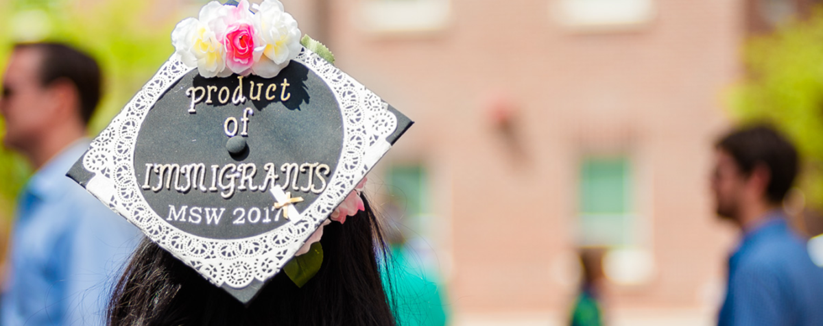 product of immigrants written on grad cap