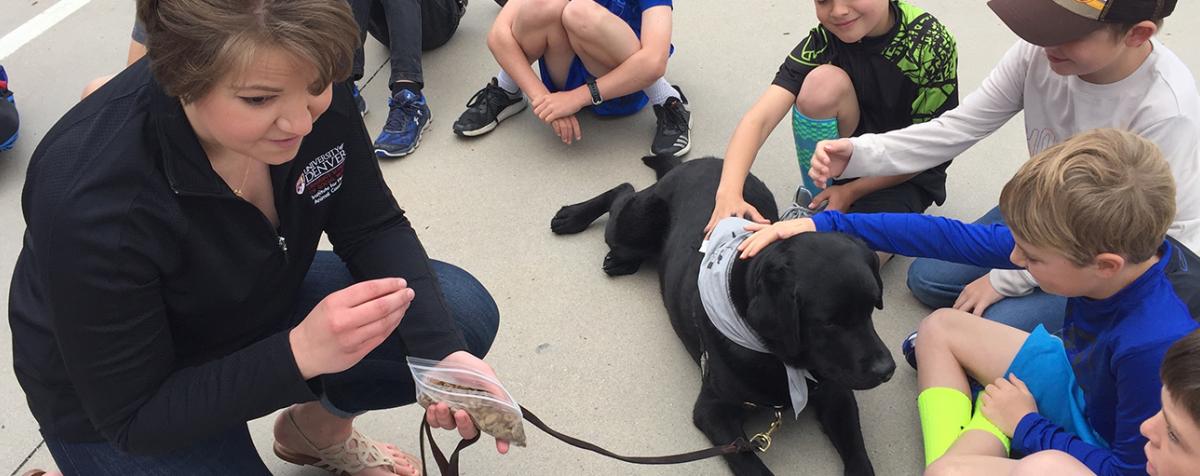 IHAC intern with children and therapy dog