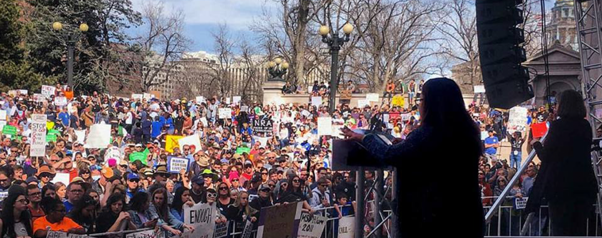 student at rally in Denver