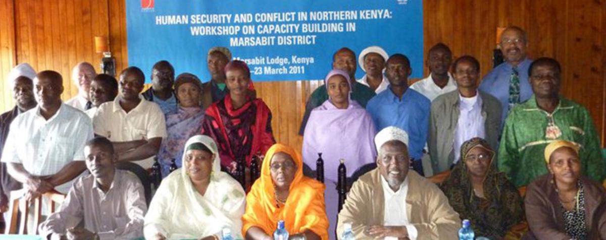 group of people in front of a banner