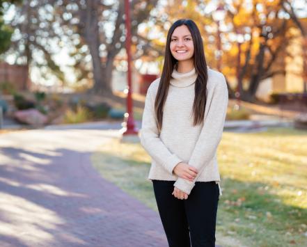 Tess Hupe standing outside on campus at DU